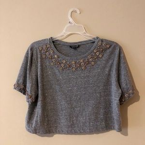 a grey crop top with jewels